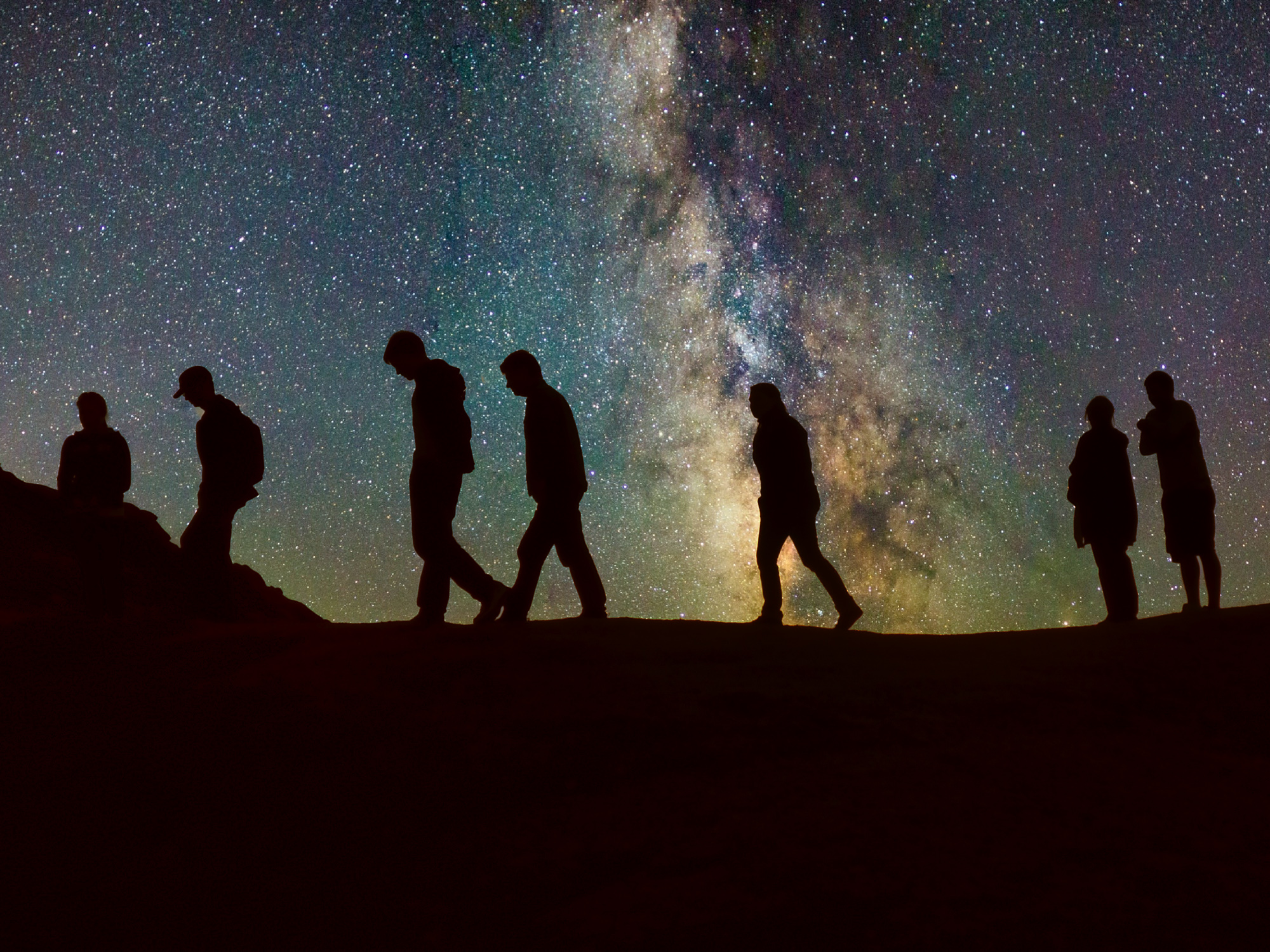 People walking in front of Milky Way