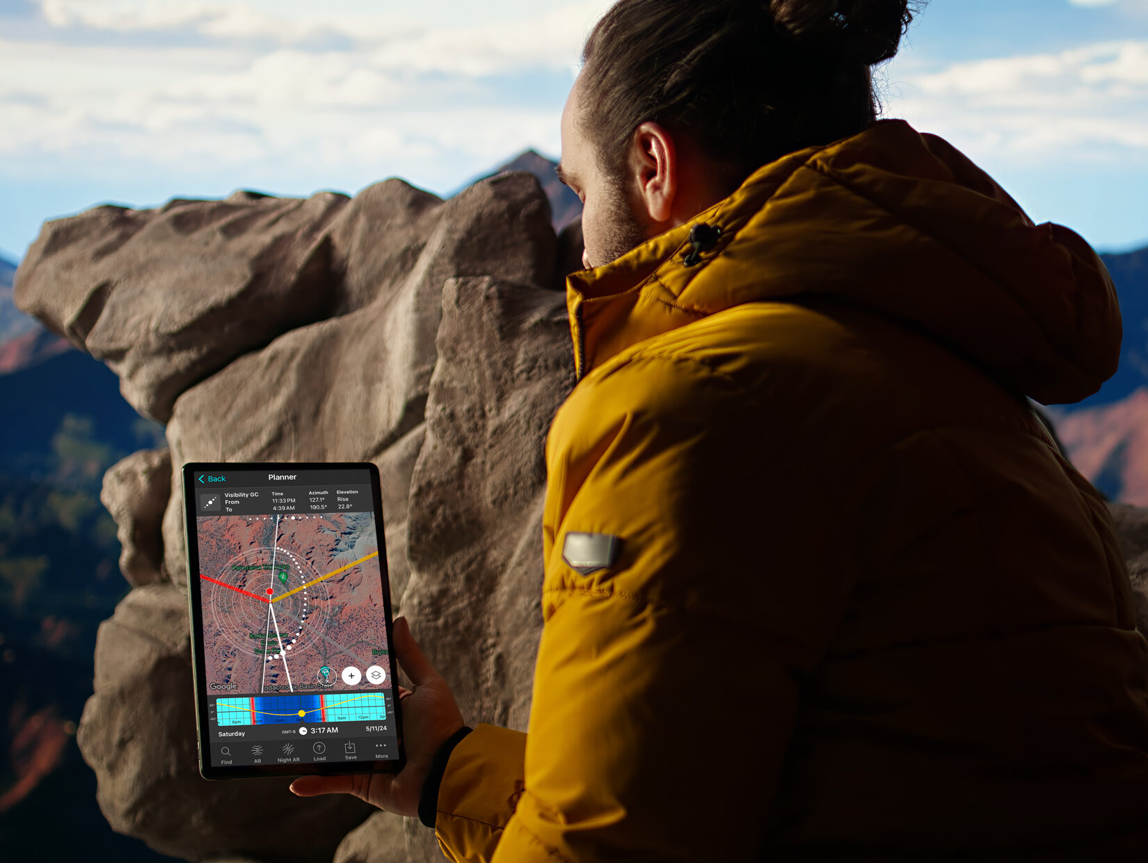 Man looking at PhotoPills app in mountains